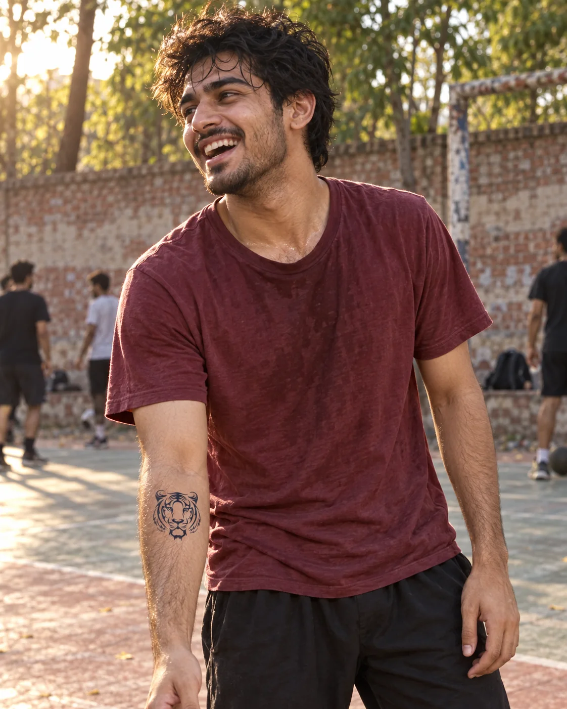 A young Pakistani man wearing a tiger temporary tattoo after a park game